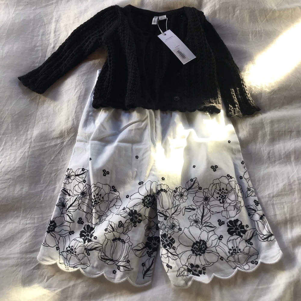 White and black romper with black sweater